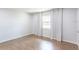 Bright bedroom with hardwood floors and large window with curtains at 411 S Oxford Dr # 411, Nokomis, FL 34275