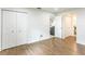 Bedroom with hardwood flooring, closets, and view into living area at 411 S Oxford Dr # 411, Nokomis, FL 34275