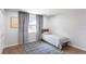 Bright bedroom with hardwood floors, gray curtains, and a comfortable bed at 411 S Oxford Dr # 411, Nokomis, FL 34275