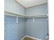 Walk-in closet with rod and colorful wallpaper at 411 S Oxford Dr # 411, Nokomis, FL 34275
