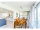 Open dining area with wood table, tile floors, and natural light at 411 S Oxford Dr # 411, Nokomis, FL 34275