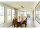 Dining room with large windows, tile flooring, and wood table with seating at 411 S Oxford Dr # 411, Nokomis, FL 34275