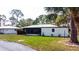 Well-maintained home with lush lawn, mature trees, and a private driveway for parking at 411 S Oxford Dr # 411, Nokomis, FL 34275