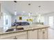 Open-concept kitchen with large island, pendant lighting, and seamless view to the comfortable living space at 411 S Oxford Dr # 411, Nokomis, FL 34275