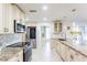 Modern kitchen featuring granite countertops, stainless steel appliances and tiled backsplash at 411 S Oxford Dr # 411, Nokomis, FL 34275