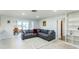 Open-concept living room with tile floors and large sectional sofa at 411 S Oxford Dr # 411, Nokomis, FL 34275