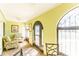 Bright sunroom with tiled floors, arched windows, seating and natural light at 411 S Oxford Dr # 411, Nokomis, FL 34275