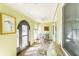 Inviting sunroom with tiled floors, arch windows, seating, and ample natural light for relaxing at 411 S Oxford Dr # 411, Nokomis, FL 34275