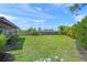 Expansive backyard showcasing the green grass, partial home exterior, perimeter landscaping, and a well-kept fence at 4320 Bent Tree Blvd, Sarasota, FL 34241