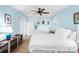 Bright bedroom featuring light blue walls, ceiling fan, and white furniture at 4320 Bent Tree Blvd, Sarasota, FL 34241