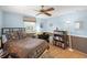 Bright bedroom featuring a comfortable bed, desk, and bookcase at 4320 Bent Tree Blvd, Sarasota, FL 34241