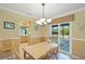 Cozy dining area with a wooden table, chairs, and sliding glass doors to the patio at 4320 Bent Tree Blvd, Sarasota, FL 34241