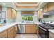 Bright eat-in kitchen featuring stainless steel appliances, tile floors, and a window at 4320 Bent Tree Blvd, Sarasota, FL 34241