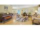 Bright living room with hardwood floors, a piano, and comfortable furniture at 4320 Bent Tree Blvd, Sarasota, FL 34241