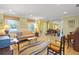 Spacious living room featuring hardwood floors, natural light, and comfortable seating arrangements at 4320 Bent Tree Blvd, Sarasota, FL 34241
