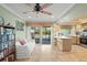 Living area with lots of natural light, access to outside, and kitchen view at 4320 Bent Tree Blvd, Sarasota, FL 34241