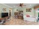 Spacious living area with tile flooring, bookshelves, and cozy seating at 4320 Bent Tree Blvd, Sarasota, FL 34241