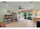 Open concept living area with tile flooring, access to outdoor living, and kitchen view at 4320 Bent Tree Blvd, Sarasota, FL 34241