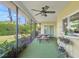Enclosed patio includes picnic seating and outdoor view to landscaping at 4320 Bent Tree Blvd, Sarasota, FL 34241