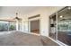 Spacious covered lanai with ceiling fan, sliding doors to backyard and interior access to kitchen at 4509 Diamond Cir, Sarasota, FL 34233