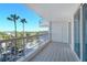 Exterior balcony showing tile flooring, metal railing, and views of mature palm trees at 455 Longboat Club Rd # 407, Longboat Key, FL 34228