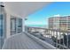 Exterior balcony showing tile flooring, metal railing, and partial views of the ocean at 455 Longboat Club Rd # 407, Longboat Key, FL 34228