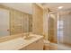 Bathroom featuring a shower, vanity, and decorative wallpaper at 455 Longboat Club Rd # 407, Longboat Key, FL 34228