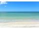 Beautiful ocean view with clear blue water and a sandy white beach with gentle waves at 455 Longboat Club Rd # 407, Longboat Key, FL 34228