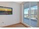 Bedroom featuring a balcony with views and beachy art on the wall at 455 Longboat Club Rd # 407, Longboat Key, FL 34228