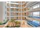 Multi story view of the building's interior featuring plants, carpeted walkways, and an open-air layout at 455 Longboat Club Rd # 407, Longboat Key, FL 34228