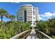 Luxury condo exterior with private balconies surrounded by lush greenery at 455 Longboat Club Rd # 407, Longboat Key, FL 34228