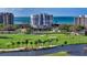 Stunning view of the golf course and waterway with the white condo buildings in the background at 455 Longboat Club Rd # 407, Longboat Key, FL 34228