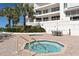 Outdoor hot tub and lounge area with ocean views at 455 Longboat Club Rd # 407, Longboat Key, FL 34228