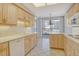 This bright kitchen features tile floors and white appliances and plenty of counter space at 455 Longboat Club Rd # 407, Longboat Key, FL 34228