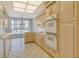 Bright kitchen with sleek appliances and ample counter space, open to the dining area at 455 Longboat Club Rd # 407, Longboat Key, FL 34228