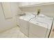 Bright laundry room with a utility sink and white washer and dryer units at 455 Longboat Club Rd # 407, Longboat Key, FL 34228