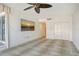Spacious living room with a tv, fan, and access to a private outdoor area at 455 Longboat Club Rd # 407, Longboat Key, FL 34228