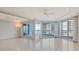 Bright living room features multiple sliding glass doors providing balcony access and lots of natural light at 455 Longboat Club Rd # 407, Longboat Key, FL 34228