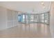 Open concept living area with tile flooring, neutral walls, and slider doors to outdoor balcony at 455 Longboat Club Rd # 407, Longboat Key, FL 34228
