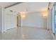 Spacious living room with tile floors, large windows, and a ceiling fan at 455 Longboat Club Rd # 407, Longboat Key, FL 34228