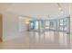 Spacious living room area with light tile floors, ceiling fans, track lighting, and stunning ocean views at 455 Longboat Club Rd # 407, Longboat Key, FL 34228