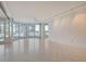 Open concept living room with white walls, tile floors, ceiling fans, track lights, and ocean views at 455 Longboat Club Rd # 407, Longboat Key, FL 34228