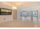 Expansive living area has tiled floors, neutral walls, and balcony access at 455 Longboat Club Rd # 407, Longboat Key, FL 34228