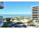 Exterior view of the condo and the ocean; showcasing the gorgeous beach and palm tree landscape at 455 Longboat Club Rd # 407, Longboat Key, FL 34228