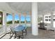 Outdoor dining area with grill overlooking a pool and ocean view at 455 Longboat Club Rd # 407, Longboat Key, FL 34228