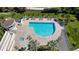 Aerial view of a luxurious pool area with a hot tub and lounge chairs at 455 Longboat Club Rd # 407, Longboat Key, FL 34228