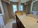 Bright bathroom featuring a large vanity, neutral tile, and a walk-in shower with glass door at 4636 72Nd E Ct, Bradenton, FL 34203