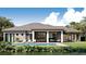 The home's rear exterior has an inviting pool, lots of outdoor space, and water views at 4644 Higel Ave, Sarasota, FL 34242