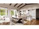 A view of the kitchen featuring hardwood floors, stone countertops, stainless appliances, and a large breakfast bar at 4644 Higel Ave, Sarasota, FL 34242