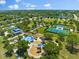This aerial shows a community park with a playground, splashpad, tennis, picnic pavilion, and green spaces at 4954 Newport News Cir, Lakewood Ranch, FL 34211